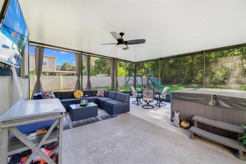 The huge screened lanai overlooks a fenced yard and wooded area!