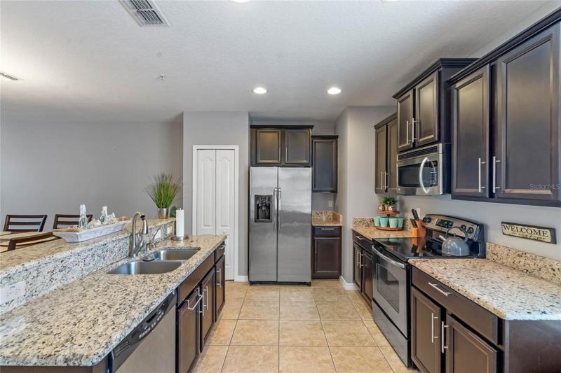 Spacious second floor kitchen with granite counters and breakfast bar.