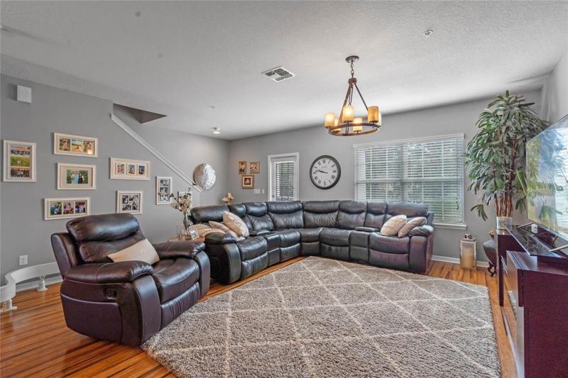 Great room on second floor has a door leading out to a covered balcony.