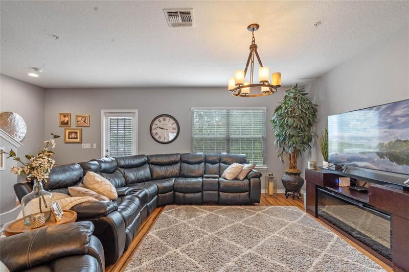 Beautiful bamboo flooring and a spacious, comfortable sectional to relax on or watch a movie.