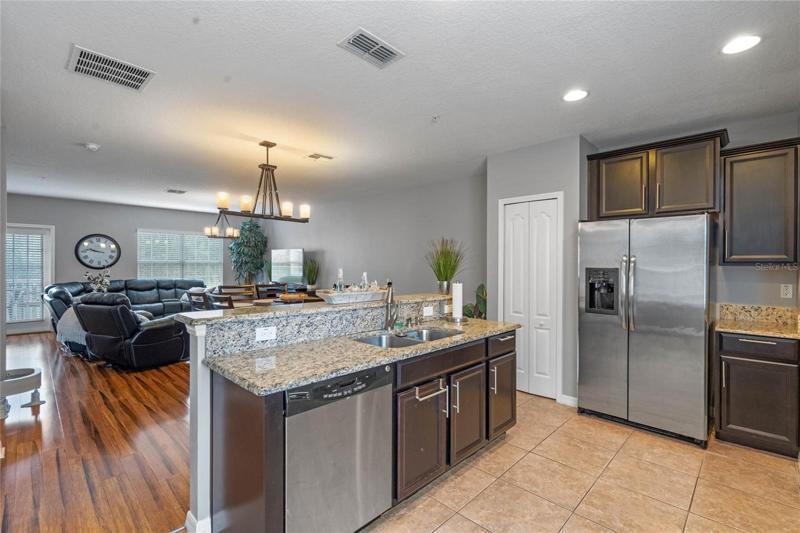 Kitchen includes stainless steel appliances and is open to the great room.