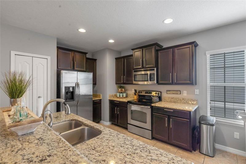 Kitchen also has a pantry and large windows.