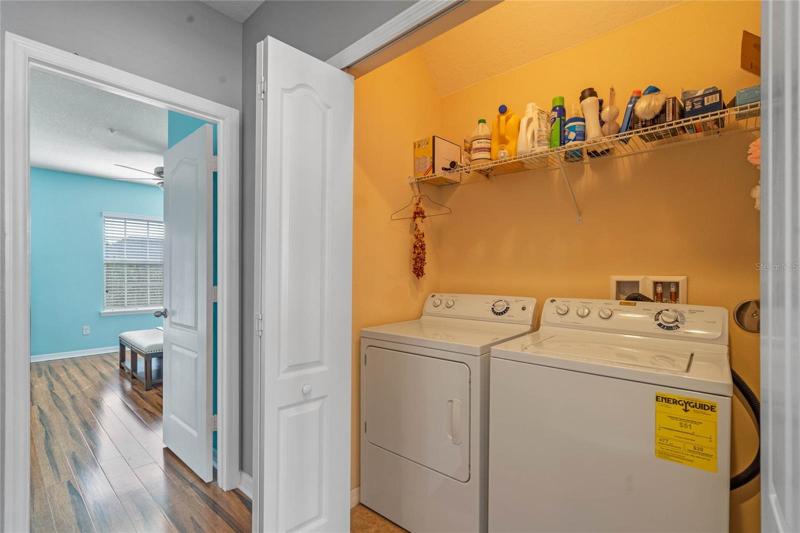 Laundry closet with washer and dryer included.