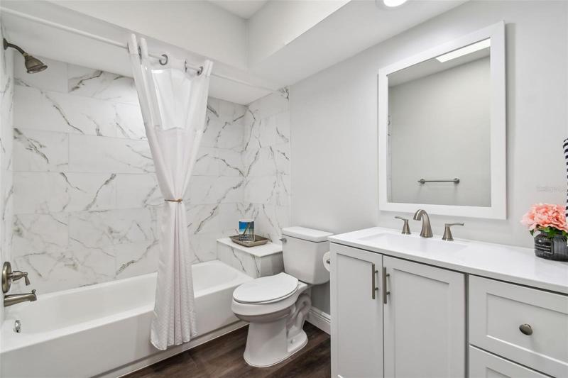 Beautifully done 2nd bath with convenient sitting ledge
