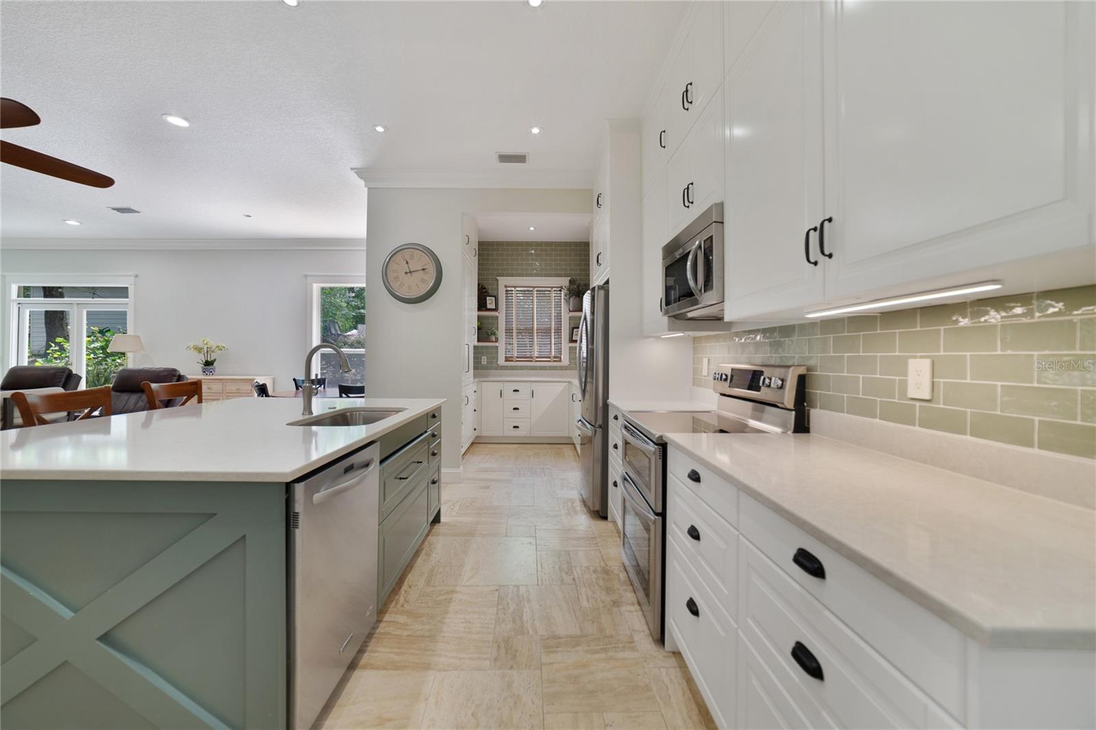 Enjoy the stainless steel appliances, subway tile backsplash, large island with breakfast bar seating and the endless storage that continues into the butlers pantry!