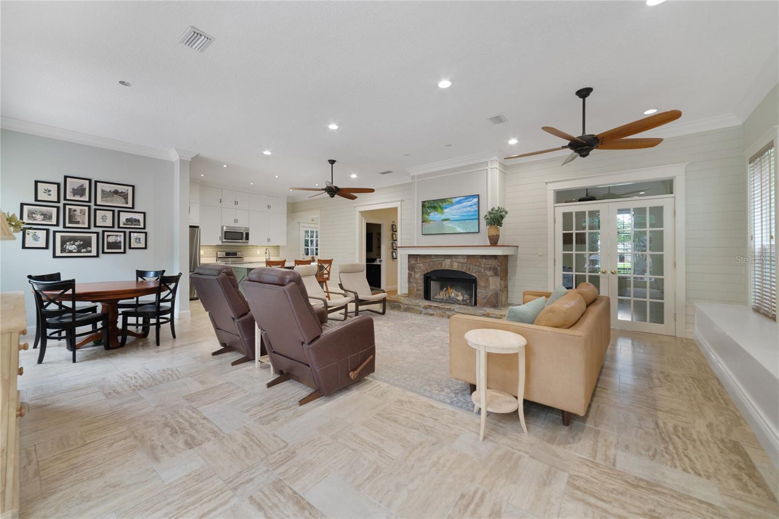 The high ceilings add to the natural light pouring in from the large windows and French doors that grant access to the patio!