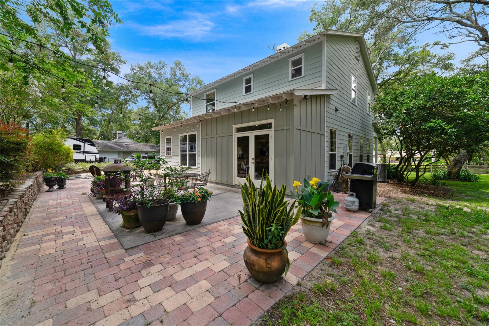 The extended PAVER PATIO is the perfect place to relax and unwind or host a weekend cookout with the expansive yard full of native mature trees as the backdrop!