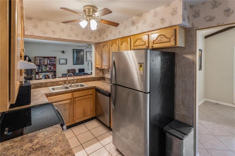 Kitchen with open area to bonus room.