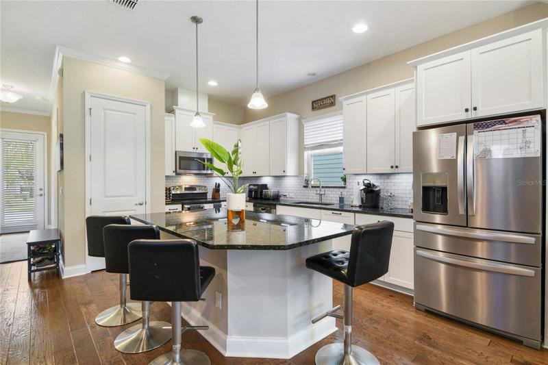 A bright open concept awaits you with WOOD FLOORS throughout the main living areas, high ceilings and upgraded finishes!