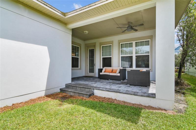 The COVERED LANAI overlooks lovely landscaping and a small private green space to enjoy the outdoors!