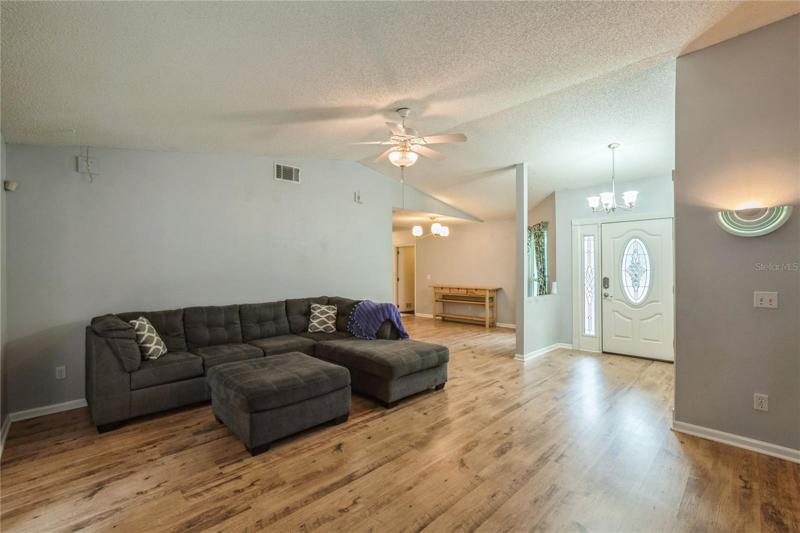 View of Living Room towards Front Entrance and Dining Room