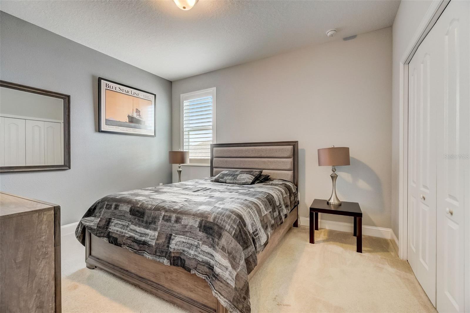 The spaciousness of this bedroom allows for an unrestricted flow of natural light, illuminating every corner and emphasizing the open and airy ambiance. The upgraded plantation shutters, with their elegant design and craftsmanship, offer both privacy and control over the amount of light streaming into the room. You have the freedom to adjust the shutters to your desired level of brightness, creating a personalized setting that suits your mood and preferences.