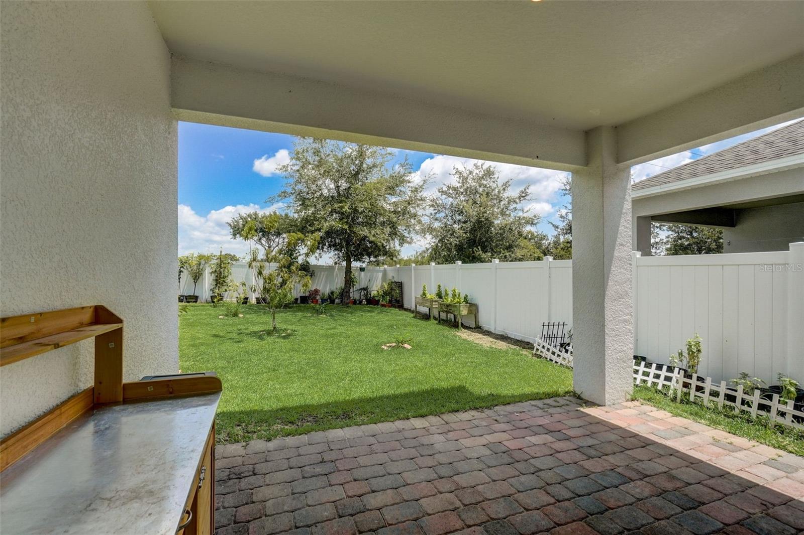 As you gaze out onto the backyard garden, you'll be captivated by the verdant greenery, colorful blossoms, and soothing sounds of nature. It becomes a private oasis where you can escape the hustle and bustle of daily life and immerse yourself in a serene and tranquil environment.The lanai serves as an extension of your living space, creating a seamless transition between indoor and outdoor living. Whether you choose to host intimate gatherings, enjoy al fresco dining, or simply relax with a book or a cup of tea, this versatile space offers endless possibilities for enjoyment and relaxation.