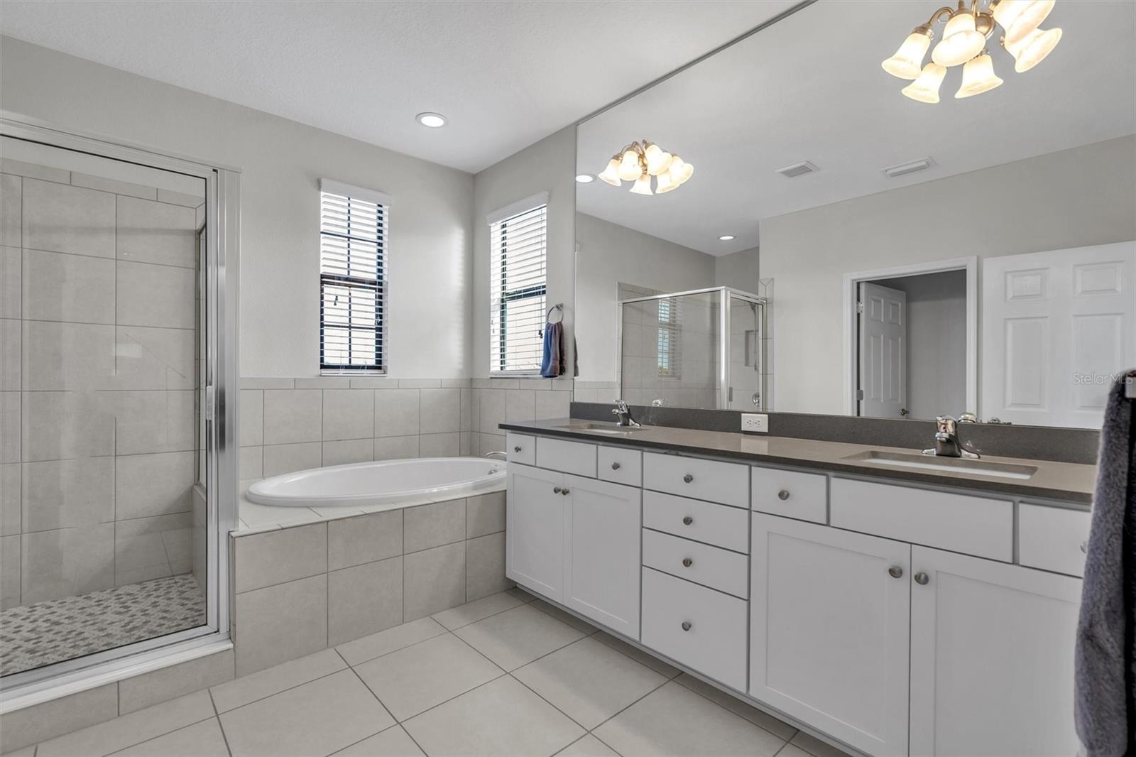 Second floor master bath with shower and separate soaking tub.
