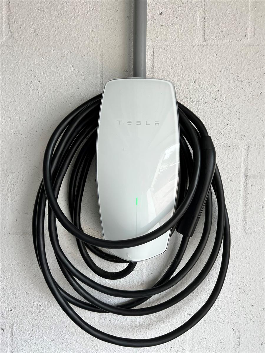 Tesla charging station installed in garage.