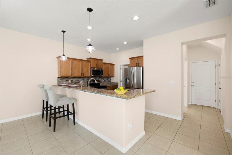 Kitchen has Large Granite Breakfast Bar!  New Pendant Lights makes the kitchen look so elegant!