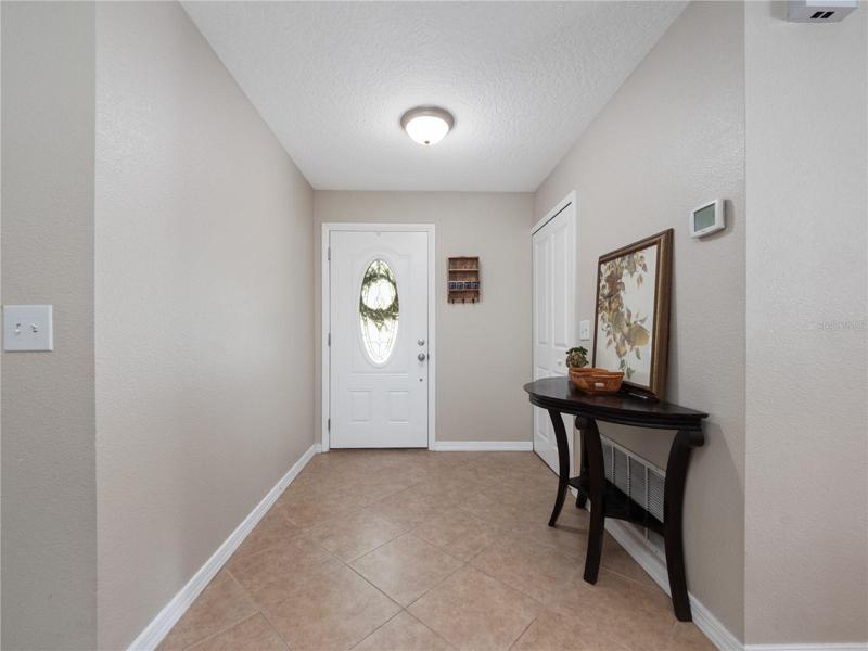The entry foyer is ample size and enjoys views through to the large backyard.