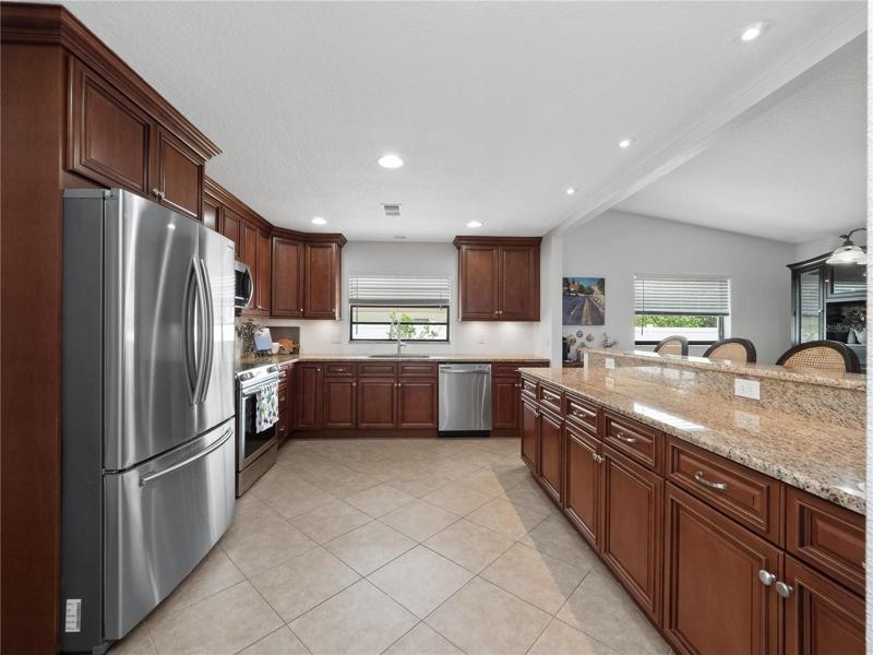 The oversized  kitchen has been updated with solid granite countertops, a large breakfast bar to gather around with seating for 3 and newer stainless steel appliances.