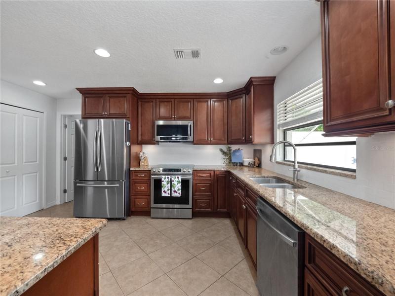 The oversized  kitchen has been updated with solid granite countertops, a large breakfast bar to gather around with seating for 3 and newer stainless steel appliances.