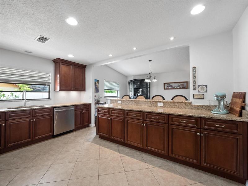 The oversized  kitchen has been updated with solid granite countertops, a large breakfast bar to gather around with seating for 3 and newer stainless steel appliances.