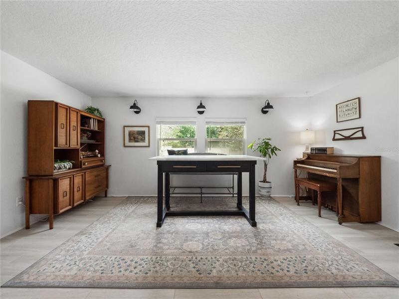 The game/bonus room is located at the back of the house and flows from the living room. There is access to the enclosed porch and large fenced backyard from the game/bonus room.