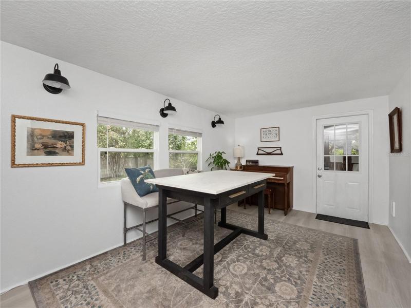 The game/bonus room is located at the back of the house and flows from the living room. There is access to the enclosed porch and large fenced backyard from the game/bonus room.