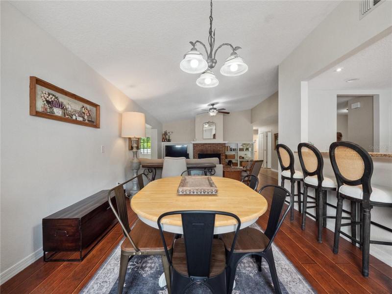 The dining room is open to the kitchen and family room and can accommodate a large table for family gatherings .