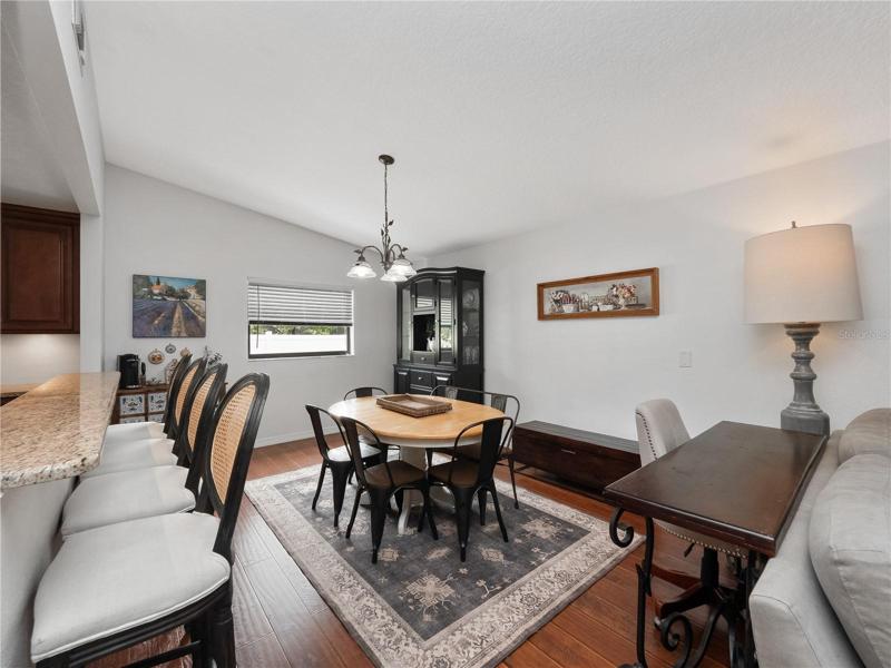 The dining room is open to the kitchen and family room and can accommodate a large table for family gatherings .