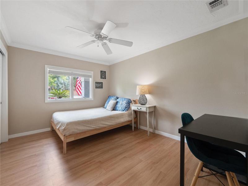 Bedroom 2 with laminate flooring, built in closets systems and tons of natural light. The hall guest bathroom is easily accessible.