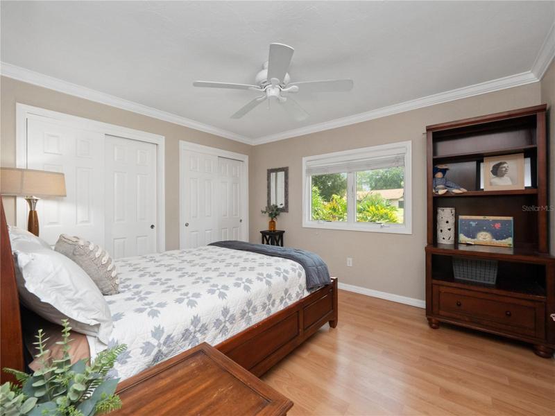 Bedroom 3 with laminate flooring, built in closets systems and tons of natural light. The hall guest bathroom is easily accessible.