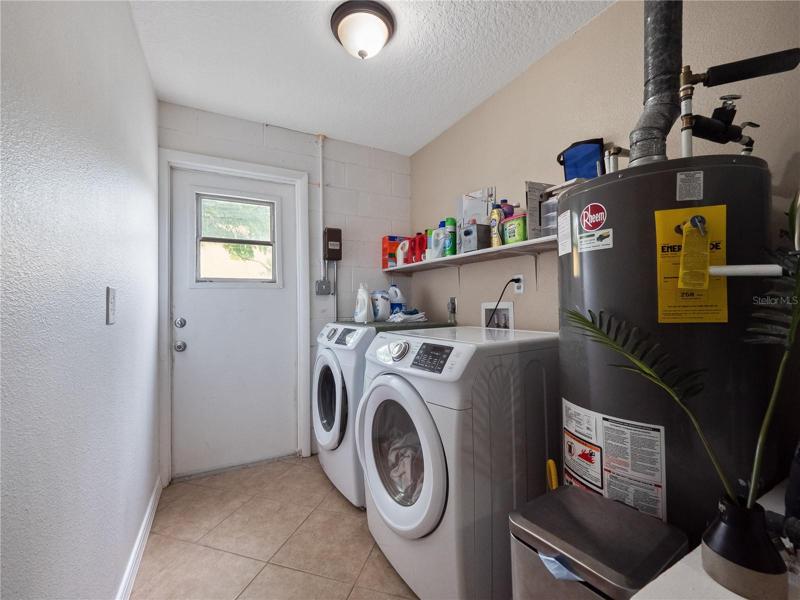 The current owner created an indoor laundry room and poured a concrete slab outside of the exterior door to store trash cans.