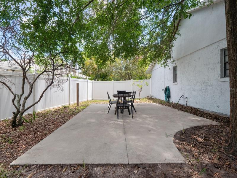 Fully fenced large backyard with fruit trees, enclosed lanai and two concrete patios.