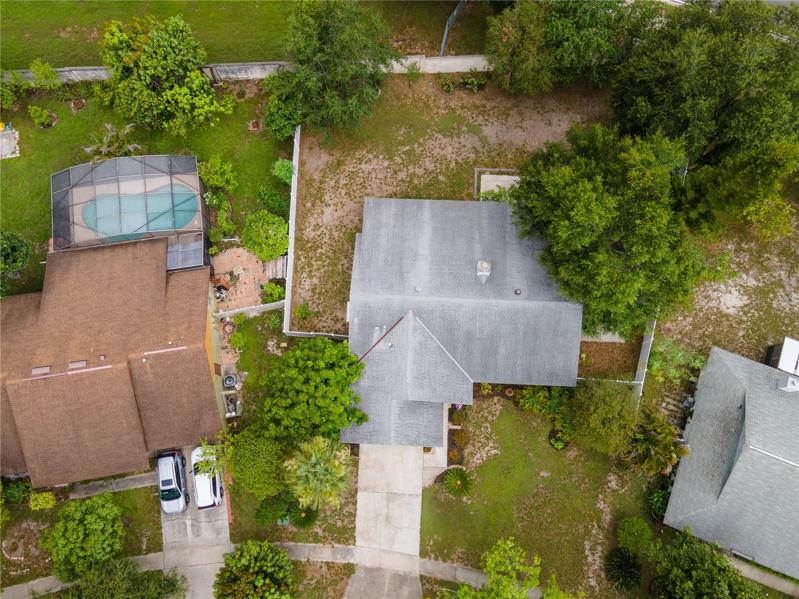 Fully fenced large backyard with fruit trees, enclosed lanai and two concrete patios.