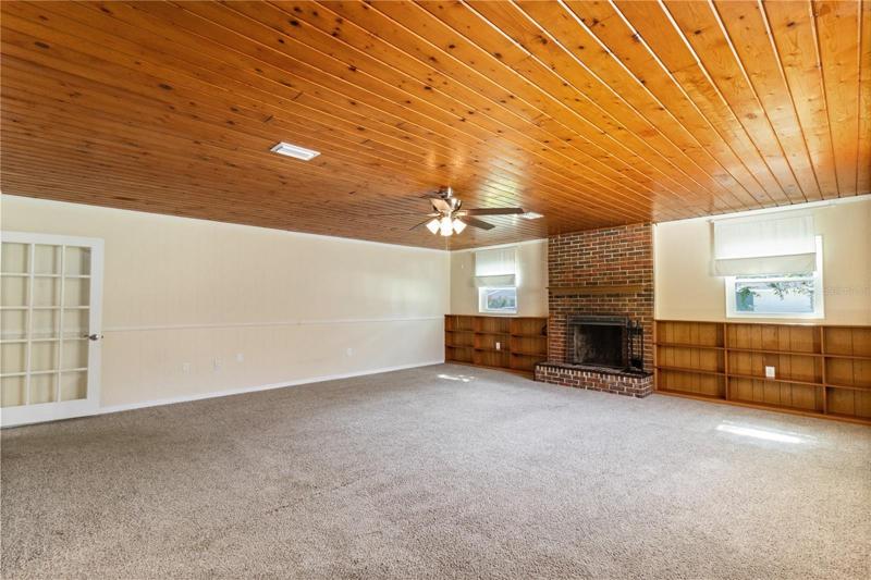 Family room W/ fireplace/built-in & shelving & exterior entrance