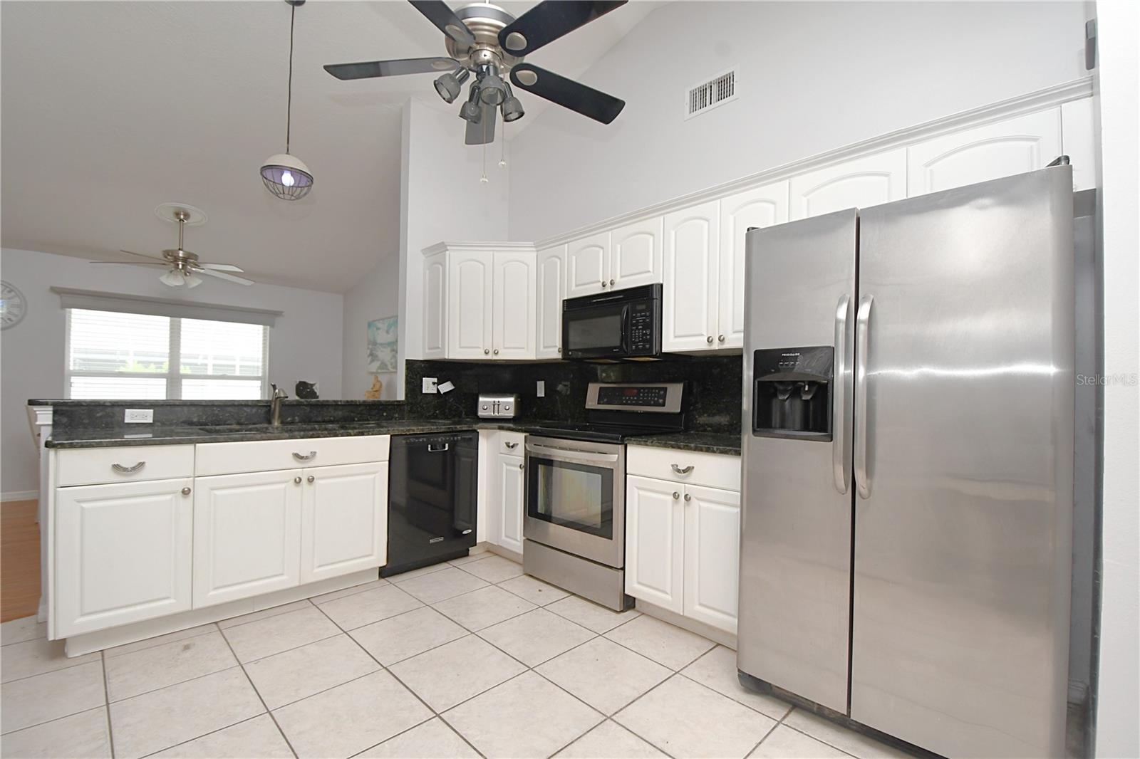 The kitchen opens to the dining and family room with a breakfast bar that seats 2-3 comfortably.