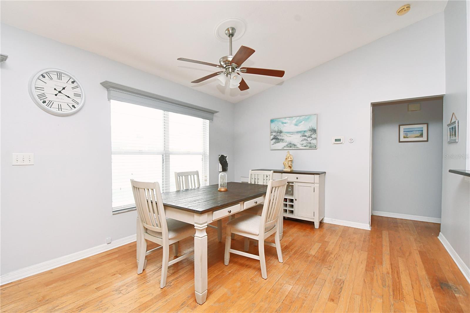 The high ceiling, wood floors and picture window make for a light and bright dining area.