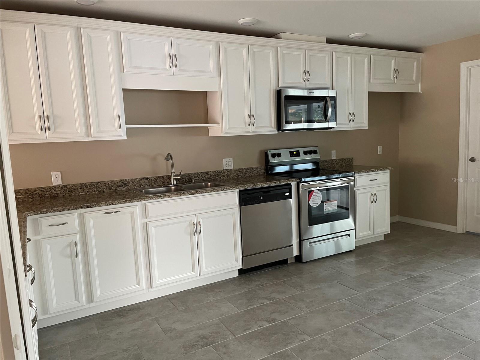 Kitchen with lot of cabinets and granite countertop
