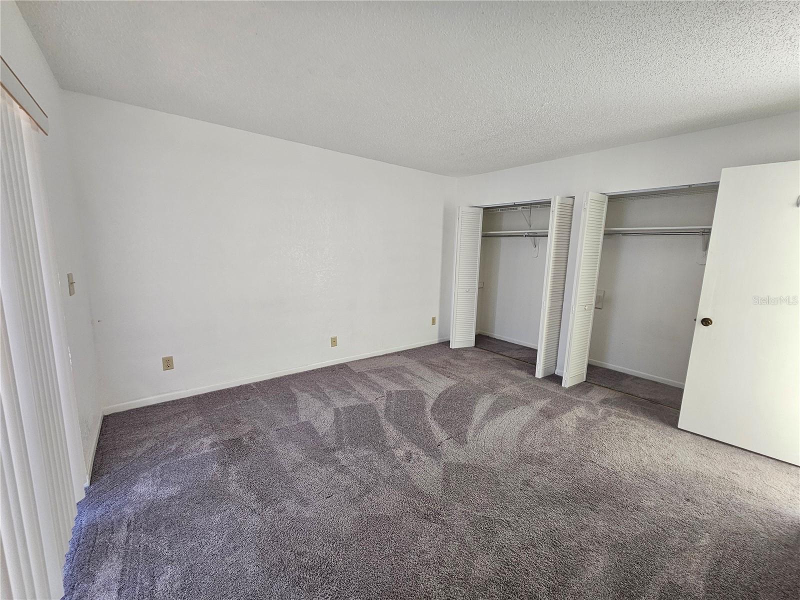 Master bedroom overlooks large screen back patio