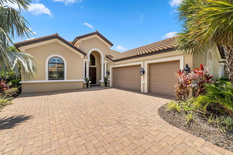Beautiful front with large paver driveway