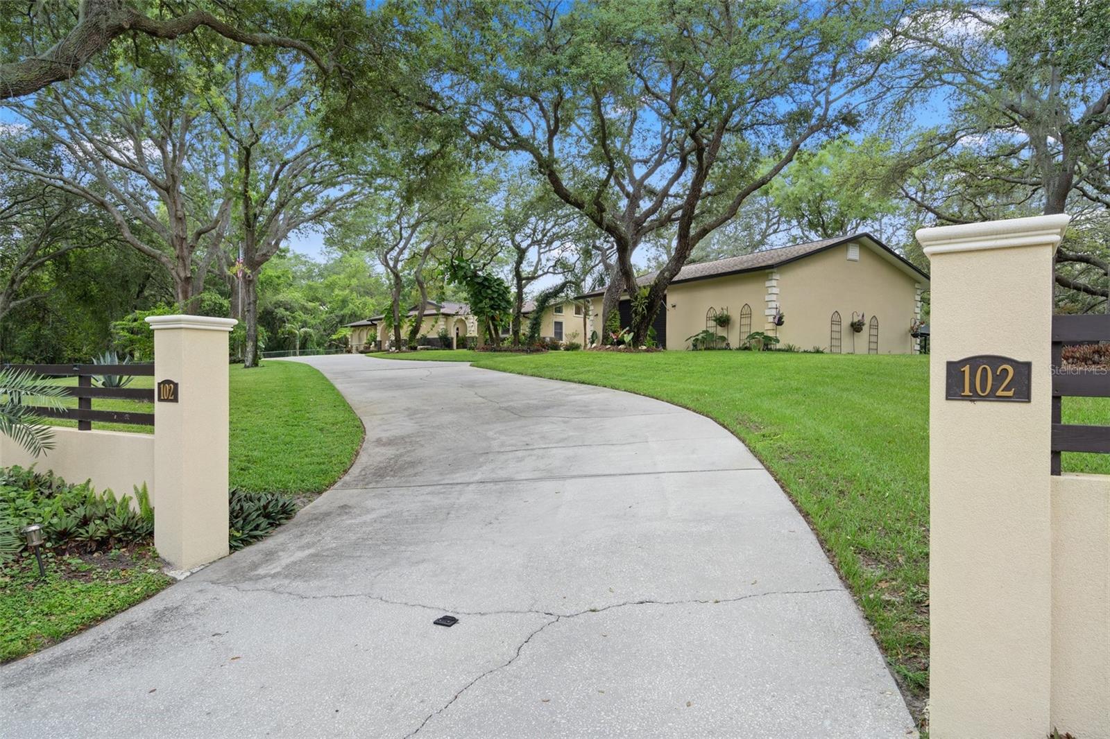 Property is private with stucco and wood beam wall surrounding it.