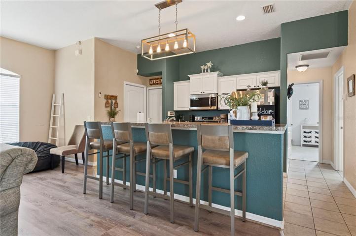 Breakfast bar off kitchen, right leads to guest bedrooms and guest bath