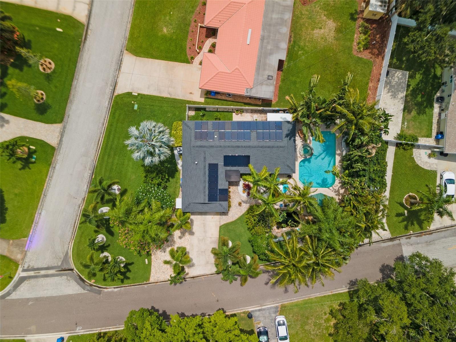 Great aerial photo of the large corner lot showing the solar panels and fabulous landscaping!
