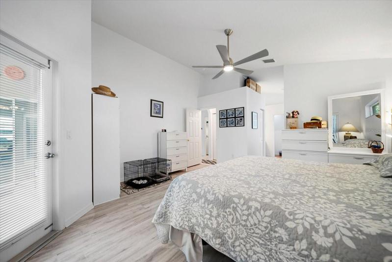 Master bedroom with doors to pool