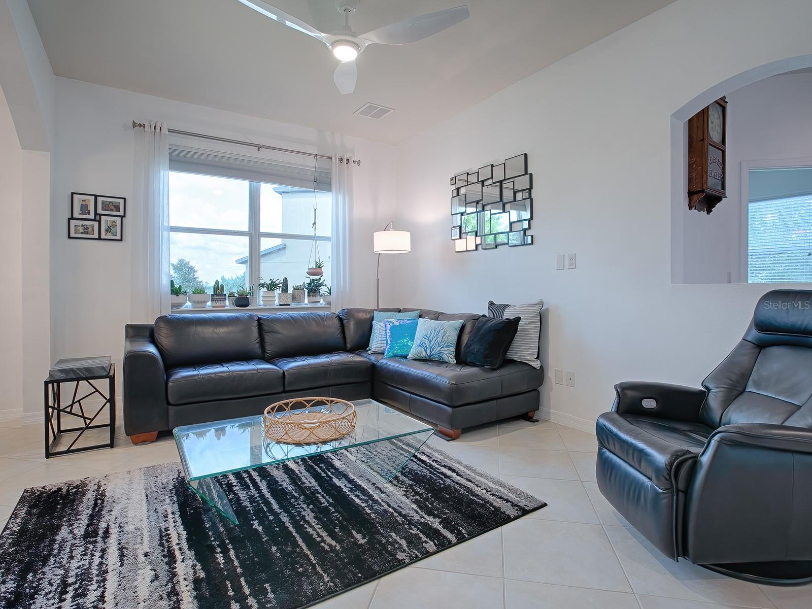 Adjacent to the dining area, this living room overlooks the well manicured side yard and all of its foliage.