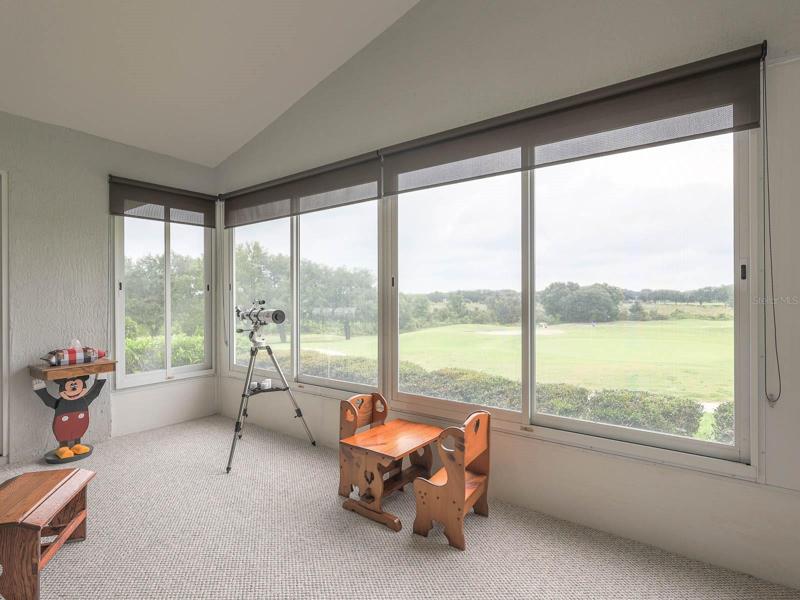 Lanai with glass windowsand shades
