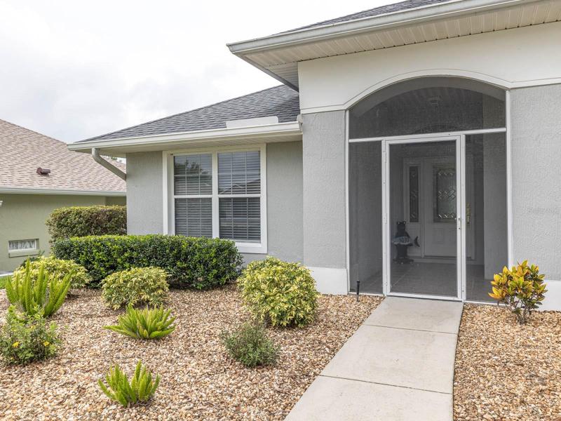 Screened in and covered front entrance