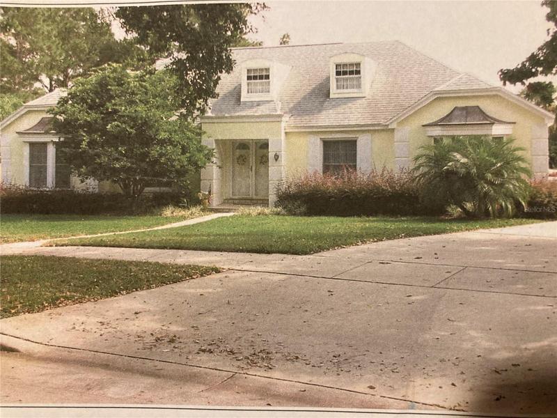 Front Exterior. Long driveway to the right and leads to rear-yard access to oversized 2-car garage.