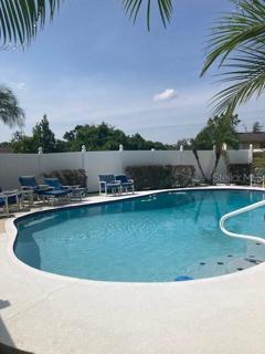 Pool with landscaping and vinyl fencing.