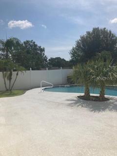 View of pool deck and palms.