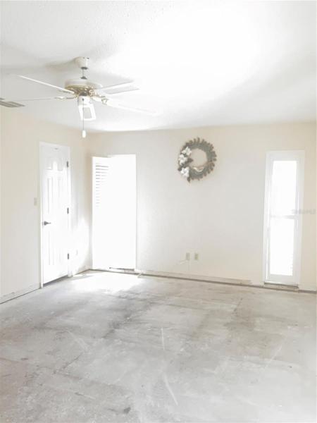 Master bedroom with walk-in closet. Leads to pool area thru sliders.
